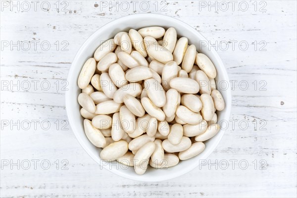 White beans raw from above wooden board