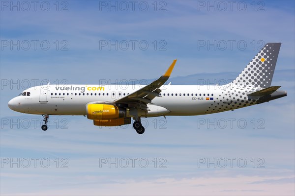 A Vueling Airbus A320 with the registration EC-MJB lands at Barcelona Airport