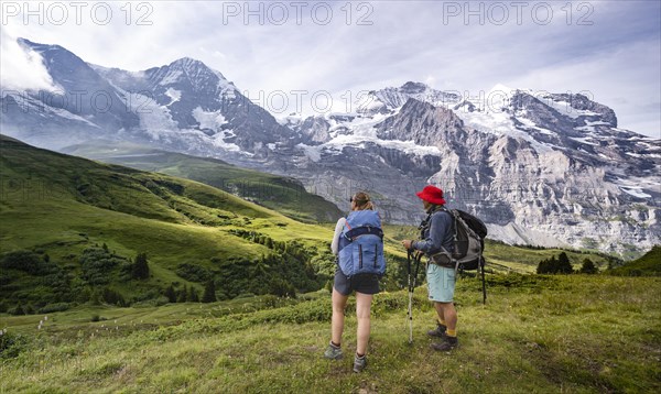 Two hikers in front of the Eiger north face