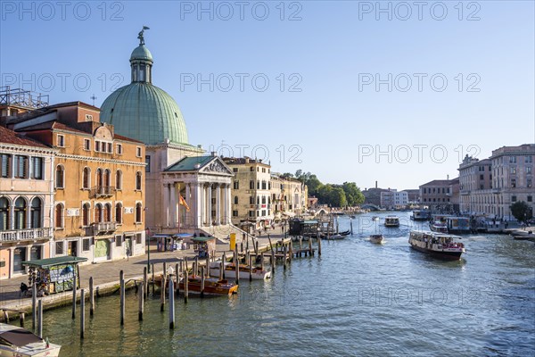 Boats on the Grand Canal with church San Simeone Piccolo at the Ponte degli Scalzi