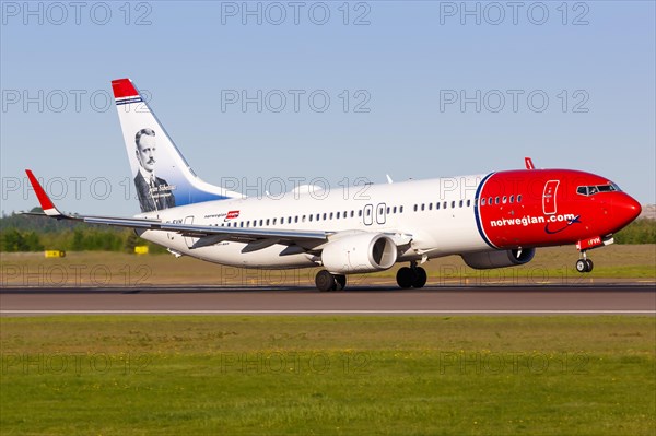 A Norwegian Boeing B737-800 with the registration EI-FVH and Jean Sibelius on the tail unit takes off from Helsinki Airport