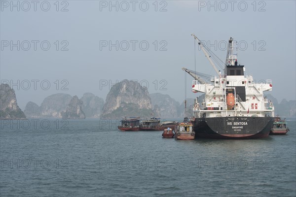 Supply ship loading or unloading cargo from coastal communities