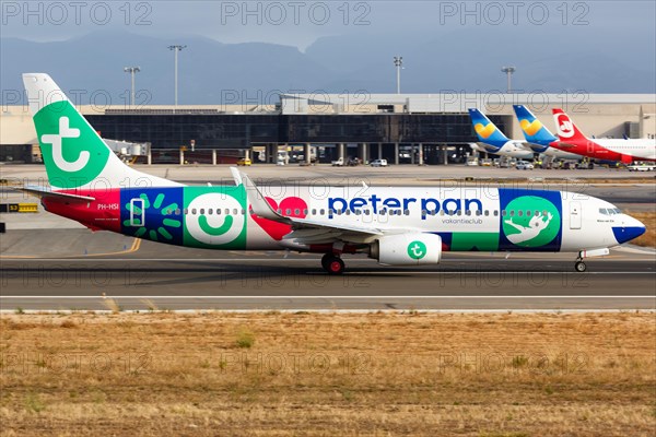A Transavia Boeing B737-800 with the registration PH-HSI and the special livery Peter Pan Vakantieclub takes off from Palma de Majorca Airport