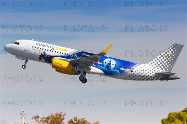 A Vueling Airbus A320 with the registration EC-MYC and the Disneyland Paris