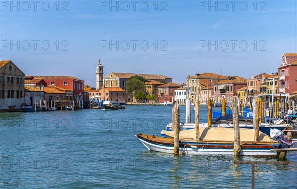 Colorful houses and boats on a canal of Murano