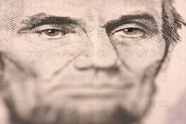 Abstract macro of U.S. five dollar bill's abraham lincoln face with narrow depth of field