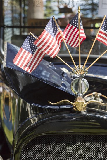 American flags on hood ornament of classic vintage car