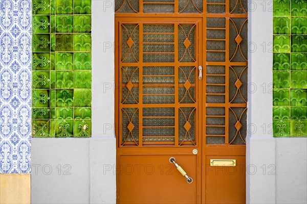 Metal doors to typical fisherman's house coverd with tiles called azulejo