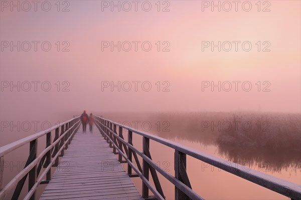 People on wooden footbridge