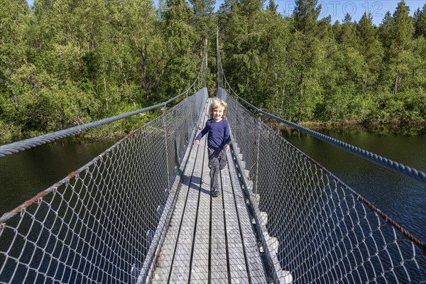 Young girl on a steel bridge