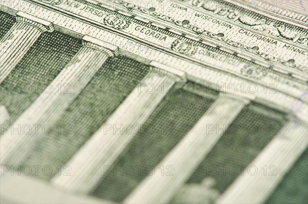 Macro of the back of the U.S. five dollar bill showing small state names as anti-counterfeit measure