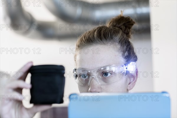 Young logistician working with scan glasses