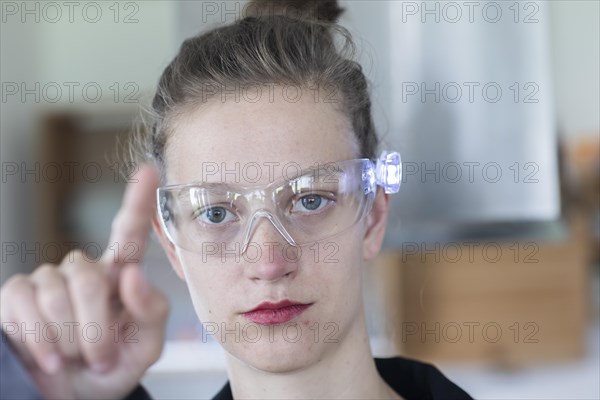 Young logistician working with scan glasses