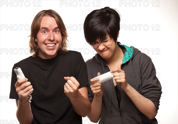 Fun happy mixed-race couple playing video game remotes isolated on a white background