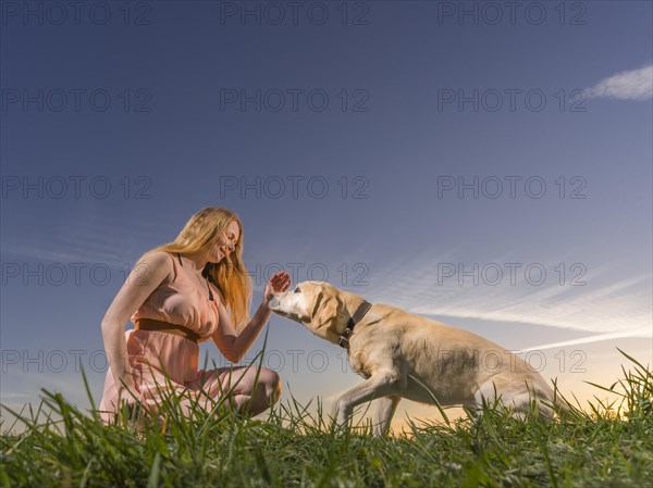 Young woman playing with dog