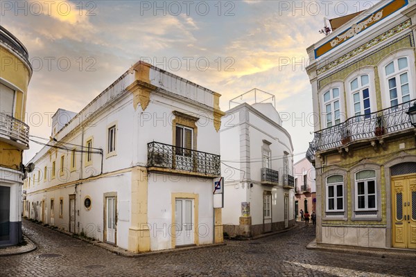 Narrow street with traditional fishermen's houses in Olhao