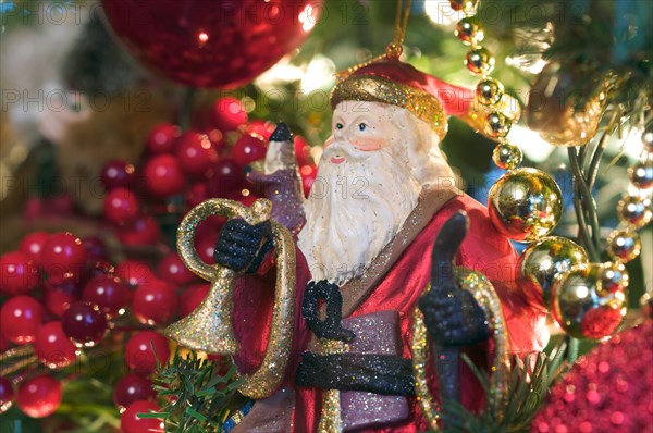 Santa ornament hanging on the christmas tree