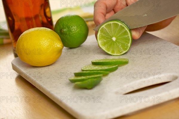 Slicing a lime on a cutting board