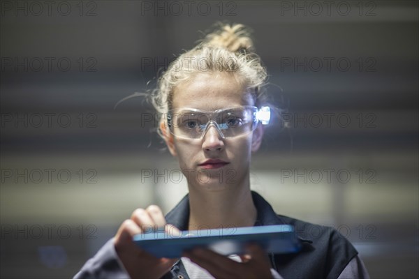 Young logistician working with scan glasses