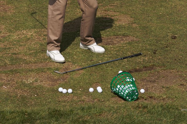 Golfer practicing his swing at the range