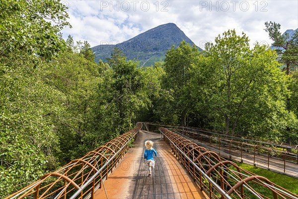 Girl walking on a very modern steel bridge