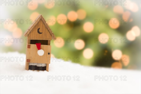 Santa in A miniature outhouse on snow over and abstract background