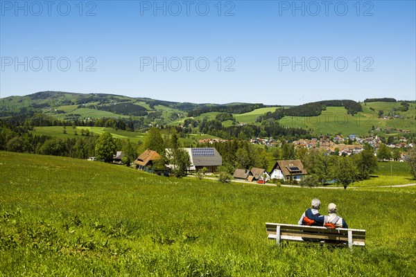 Elderly hiker couple on a bench