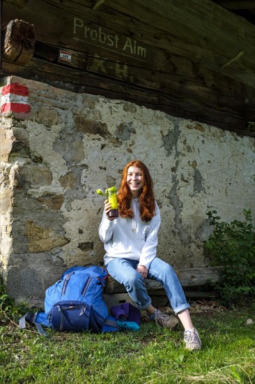 Hiker resting at a small alpine hut