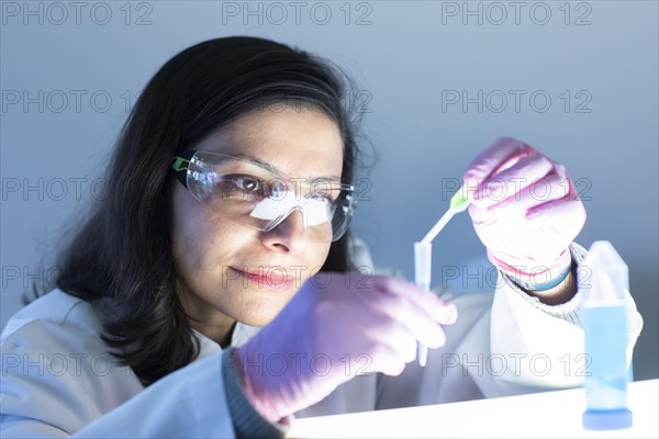 Middle aged technician in laboratory with lab coat