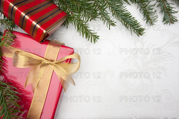 Silk christmas background with gifts and pine branches