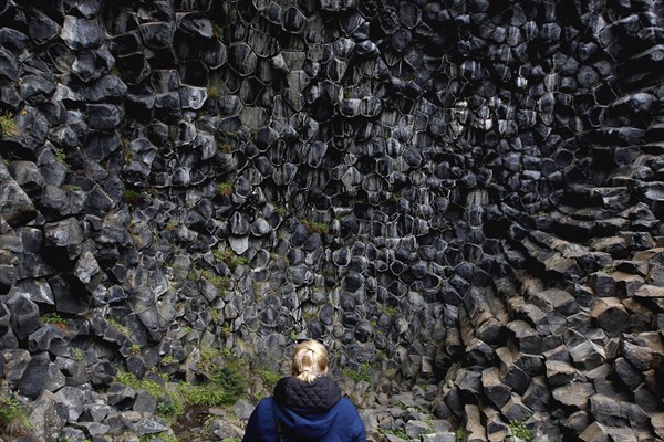 Woman in front of column basalt