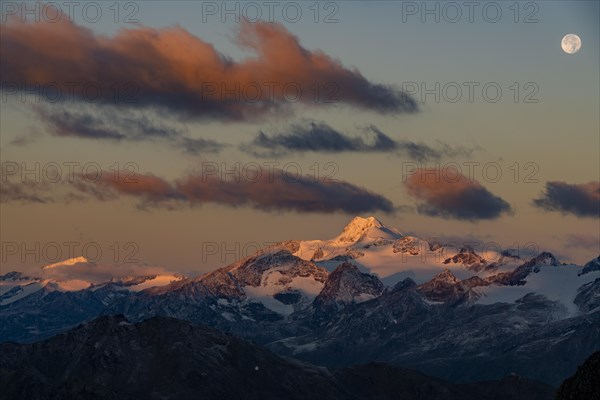 Full moon over summit of Oetztaler Wildspitze