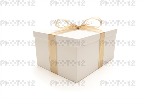 White gift box with gold ribbon and bow isolated on a white background