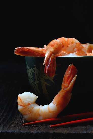 Cooked prawns in shell with chopsticks