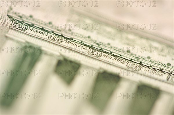 Macro of the back of the U.S. five dollar bill showing small state names as anti-counterfeit measure