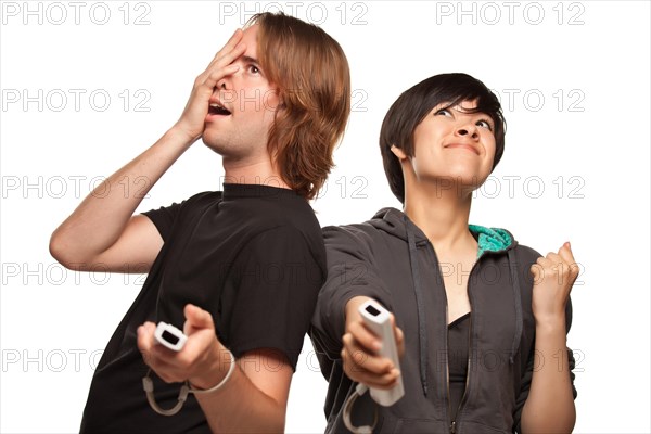 Fun happy mixed-race couple playing video game remotes isolated on a white background