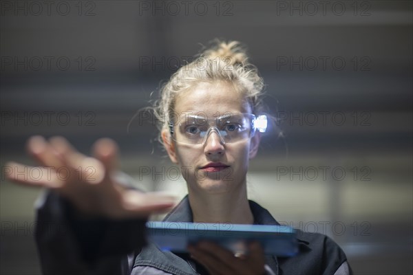 Young logistician working with scan glasses