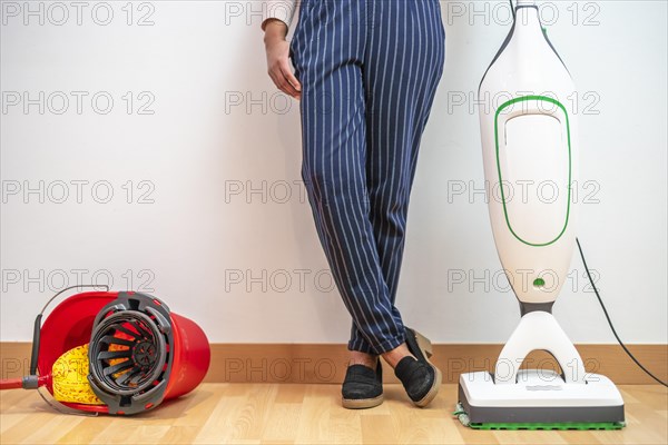Woman prefers modern electric mop combined with vacuum cleaner than old bucket and mop