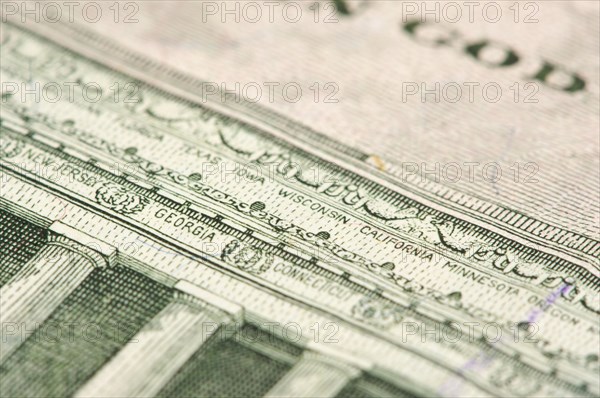 Macro of the back of the U.S. five dollar bill showing small state names as anti-counterfeit measure