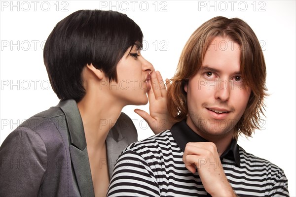 Attractive diverse couple whispering secrets isolated on a white background