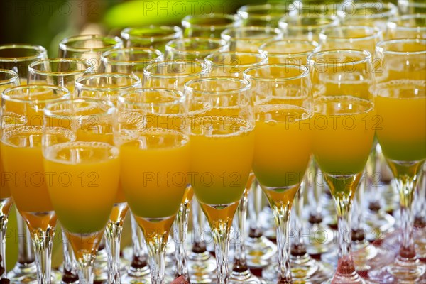 Glass of orange juice cocktail during a wedding party at Domaine 7 Cascades