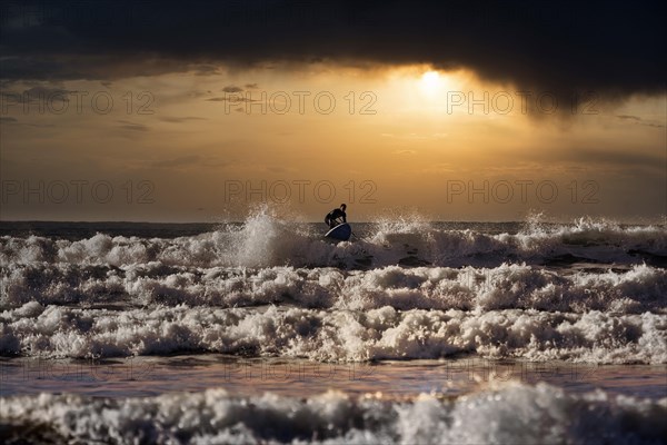 Person on stand-up paddle in the surf