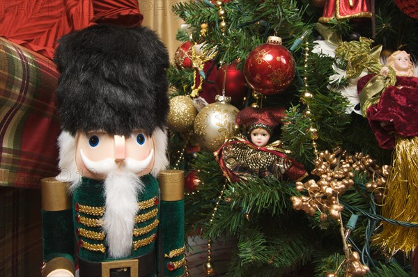 Nutcracker and christmas decorations around the tree