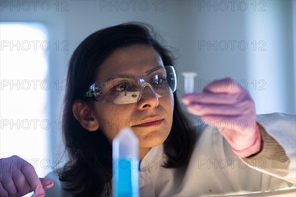 Middle aged technician in laboratory with lab coat