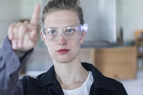Young logistician working with scan glasses