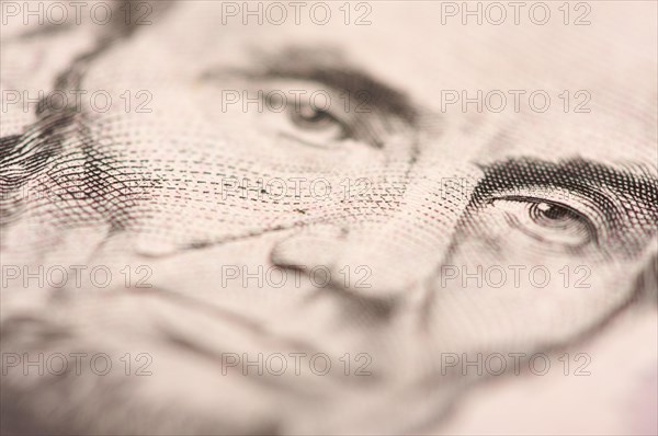 Abstract macro of U.S. five dollar bill's abraham lincoln face with narrow depth of field
