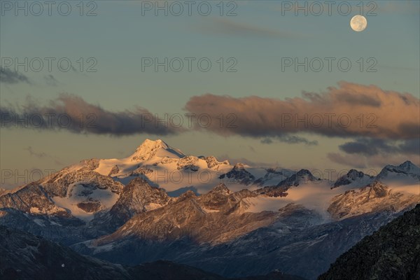 Full moon over summit of Oetztaler Wildspitze