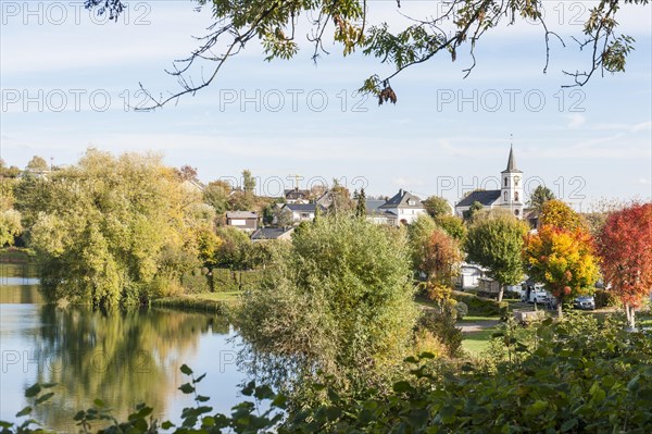 Lake Schalkenmehrener Maar in autumn with foliage colouring