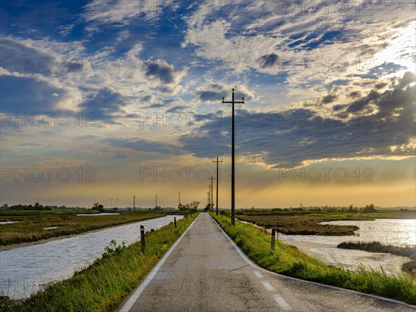 Single lane road through the Venice lagoon in the evening light