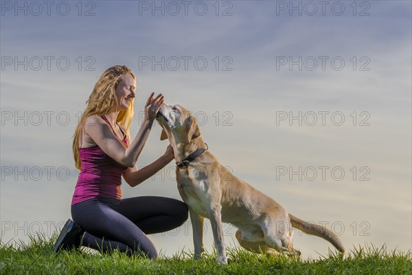 Young woman playing with dog